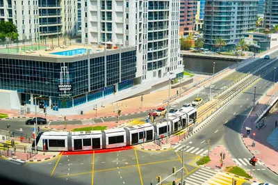 a city street with a white and red train at Upgraded 1Bedroom next to JBR Tourist Destination in Dubai