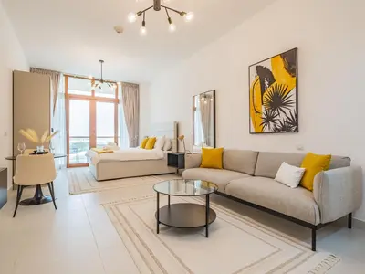 a living room with a couch and a table at Paradise Studio in Palm Views - Palm Jumeirah in Dubai