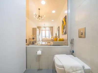 a bathroom with a toilet and a bed in a room at Paradise Studio in Palm Views - Palm Jumeirah in Dubai