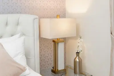 a lamp on a side table next to a bed at Elite Royal Apartment Full Burj Khalifa & Fountain View - Czar in Dubai