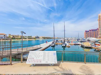 a marina with boats in the water and a sign at Minimalistic Studio in Palm Views - Palm Jumeirah in Dubai