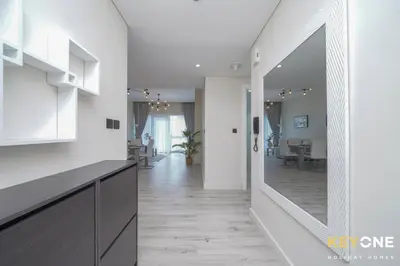 a hallway with a mirror and a dining room at Chic Marina View Living in a Two Bedroom in Dubai