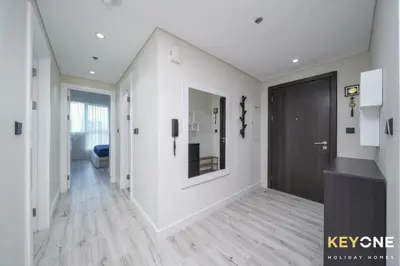 a hallway with white walls and a black door at Chic Marina View Living in a Two Bedroom in Dubai