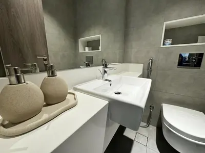 a bathroom with a sink and a toilet at Panoramic 1br with Crystal Lagoon & Downtown View in Dubai