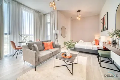 a living room with a couch and a bed at Picturesque Studio at Mesk 1 Midtown Dubai Production City by Deluxe Holiday Homes in Dubai