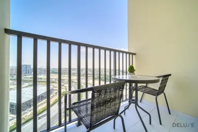 a balcony with a table and chairs and a view at Graceful Studio at Mesk 1 Midtown Dubai Production City by Deluxe Holiday Homes in Dubai