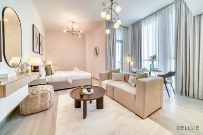 a bedroom and living room with a bed and a couch at Classic Studio at Mesk 1 Midtown Dubai Production City by Deluxe Holiday Homes in Dubai
