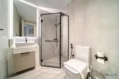 a bathroom with a shower and a toilet and a sink at Classic Studio at Mesk 1 Midtown Dubai Production City by Deluxe Holiday Homes in Dubai