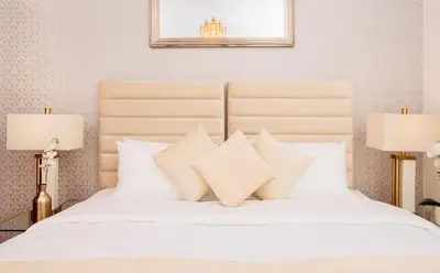 a bedroom with a white bed with two lamps at Elite Royal Apartment - Full Burj Khalifa & Fountain View - King in Dubai