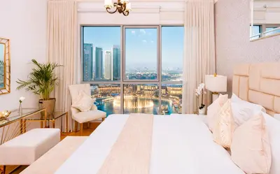 a hotel room with a bed and a large window at Elite Royal Apartment - Full Burj Khalifa & Fountain View - King in Dubai