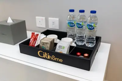 a tray with bottles of water sitting on a counter at CitiHome - Newly Furnished Apartment in Business Bay in Dubai