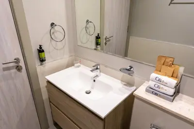 a bathroom with a sink and a mirror at CitiHome - Newly Furnished Apartment in Business Bay in Dubai