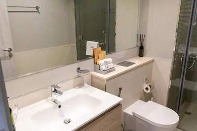 a bathroom with a sink and a toilet and a mirror at CitiHome - Newly Furnished Apartment in Business Bay in Dubai