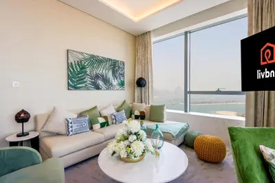 a living room with a couch and a table at Livbnb - 1BR w/Spectacular Sea Views in Palm Tower in Dubai
