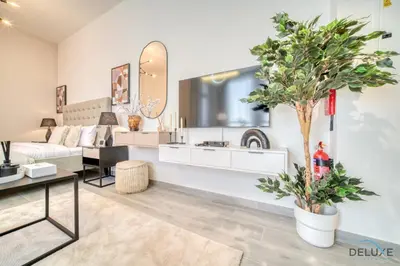 a living room with a couch and a table at Distinguished Studio at Mesk 1 Midtown Dubai Production City by Deluxe Holiday Homes in Dubai