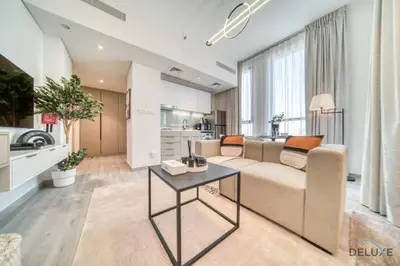 a living room with a couch and a table at Distinguished Studio at Mesk 1 Midtown Dubai Production City by Deluxe Holiday Homes in Dubai