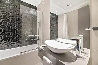a bathroom with a sink and a shower at Silkhaus luxurious 1BDR in AG Tower, Business Bay in Dubai