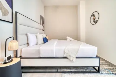 a bedroom with a white bed in a room at Incredible Studio at Mesk 1 Midtown Dubai Production City by Deluxe Holiday Homes in Dubai