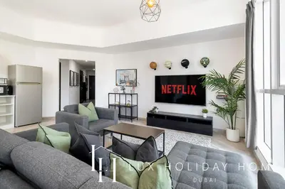a living room with a couch and a table at LUX The Dubai Marina View Suite in Dubai