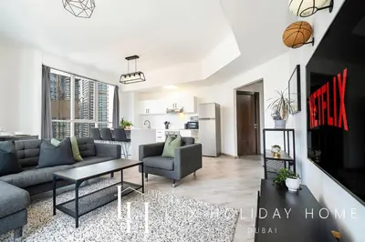 a living room with a couch and a table at LUX The Dubai Marina View Suite in Dubai