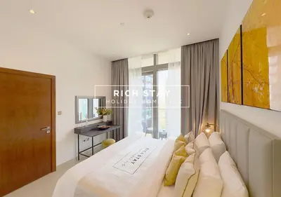 a bedroom with a large white bed and a window at Phenomenal 1BR in Marina Gate 2,Full Marina View in Dubai