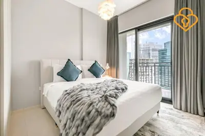 a bedroom with a white bed with a large window at Keysplease New 1 BR Apt Business Bay, Zada Tower in Dubai