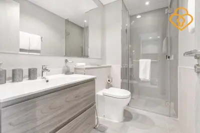 a white bathroom with a toilet and a shower at Keysplease New 1 BR Apt Business Bay, Zada Tower in Dubai