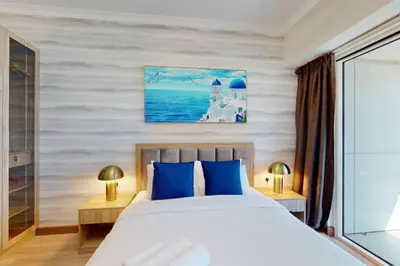 a bedroom with a bed with blue pillows at Saba Tower 3 - Elegant Studio Apartment in Dubai