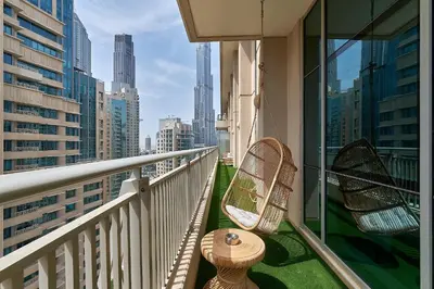 a balcony with chairs and a view of a city at BellaVista - Spectacular - 2 BR Penthouse - Boulevard Central - Panoramic Terrace & Burj Khalifa View in Dubai
