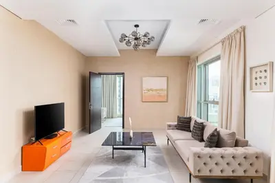 a living room with a couch and a tv at BellaVista - Spectacular - 2 BR Penthouse - Boulevard Central - Panoramic Terrace & Burj Khalifa View in Dubai