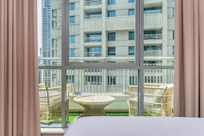 a room with a window with a table and chairs at BellaVista - Spectacular - 2 BR Penthouse - Boulevard Central - Panoramic Terrace & Burj Khalifa View in Dubai