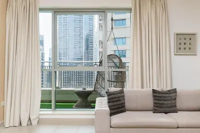 a living room with a couch and a large window at BellaVista - Spectacular - 2 BR Penthouse - Boulevard Central - Panoramic Terrace & Burj Khalifa View in Dubai