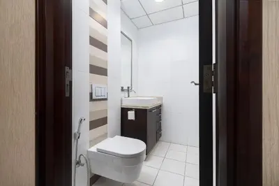 a small bathroom with a toilet and a sink at BellaVista - Spectacular - 2 BR Penthouse - Boulevard Central - Panoramic Terrace & Burj Khalifa View in Dubai