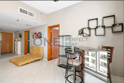 a living room with a table and chairs in a room at Lake View All Bills Included Fully furnished in Dubai