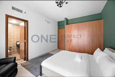 a bedroom with a bed and a sign on the wall at Lake View All Bills Included Fully furnished in Dubai