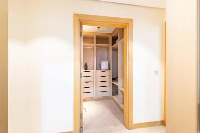 a room with a closet with white walls at Dubai The Palm 4BR Beach & Pool Access in Dubai