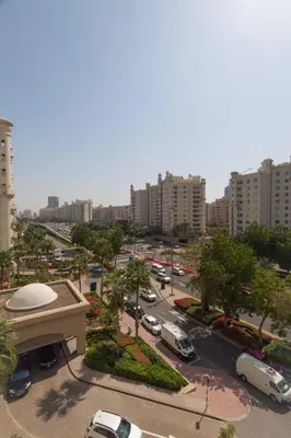 a view of a city with cars parked in a parking lot at Dubai The Palm 4BR Beach & Pool Access in Dubai