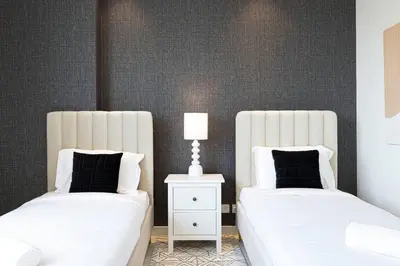 two beds sitting next to each other in a bedroom at Magnificent - Luxurious 3 BR with Marina View in Dubai