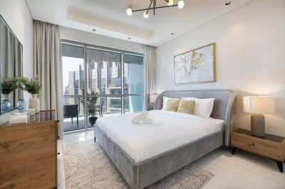 a bedroom with a bed and a large window at Magnificent - Luxurious 3 BR with Marina View in Dubai