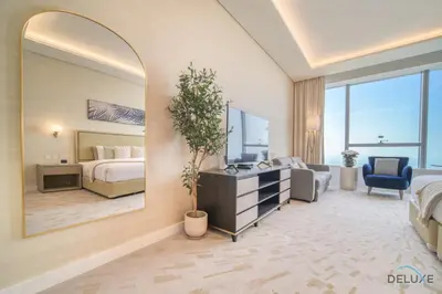 a hotel room with a bed and a mirror at Heavenly Studio at The Palm Tower Palm Jumeirah by Deluxe Holiday Homes in Dubai