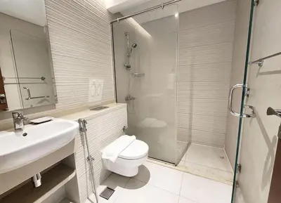 a bathroom with a toilet and a sink and a shower at RH- Captivating Skyline View, 02BR Near Clemance Medical Center in Dubai