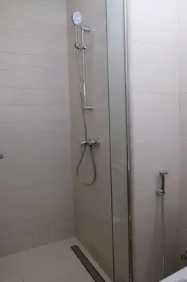 a shower with a glass door in a bathroom at Mira Holiday Homes - Cozy studio in Meydan in Dubai