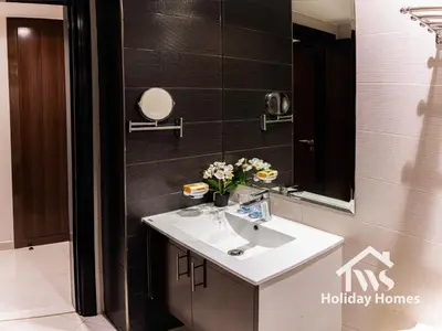 a bathroom with a sink and a mirror at The Urban Oasis - Serenity in Dubai
