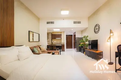 a bedroom with a large bed and a living room at The Urban Oasis - Serenity in Dubai