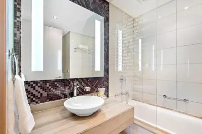 a bathroom with a white sink and a mirror at ALiving Luxury 2BR I Paramount Towers, Business Bay- 6106 in Dubai