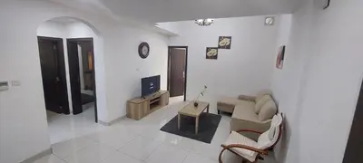 a living room with a couch and a tv at Cute Rooms and Small Partitions for Girls in Dubai- Female guests only فتيات فقط in Dubai