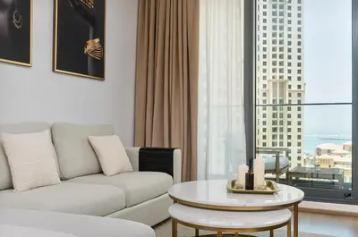a living room with a couch and a table at New apt in Dubai Marina with balcony and sea view in Dubai
