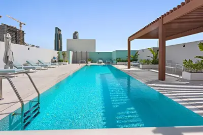 a swimming pool on top of a building at Silkhaus new furnished studio in JVC, Luma 21 in Dubai