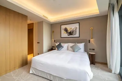 a bedroom with a large white bed in a room at Premium 1BDR Apartment in Downtown Opera in Dubai