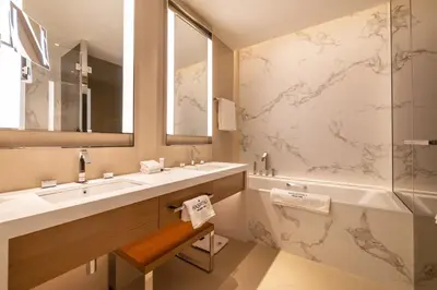 a bathroom with two sinks and a large mirror at Premium 1BDR Apartment in Downtown Opera in Dubai